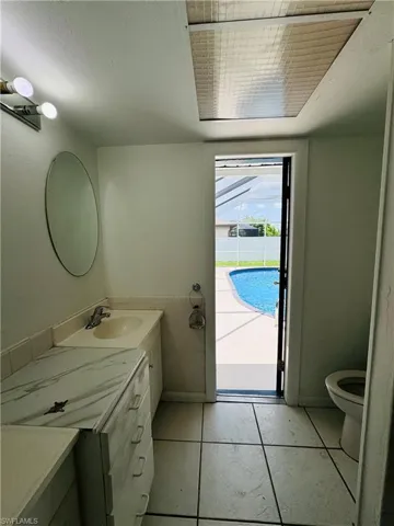 Bathroom with vanity, tile patterned flooring, and toilet