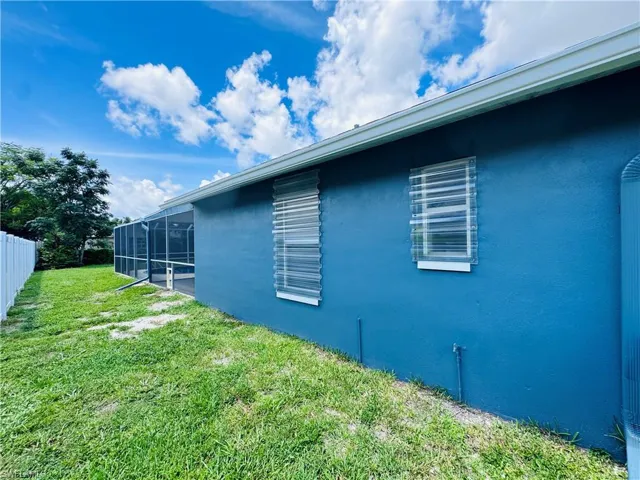 View of home's exterior with a yard