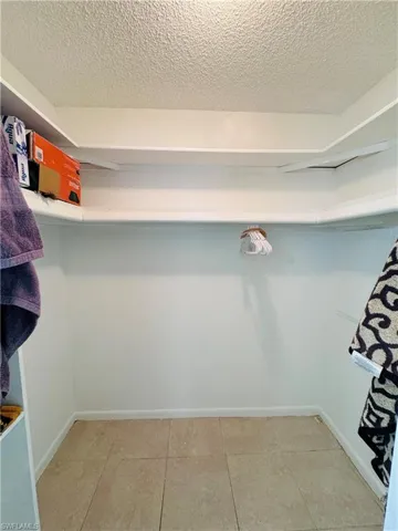 Spacious closet featuring tile patterned flooring