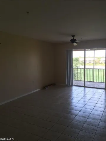 Unfurnished room featuring ceiling fan and tile patterned floors