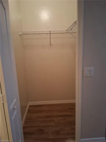Walk in closet featuring wood finished floors