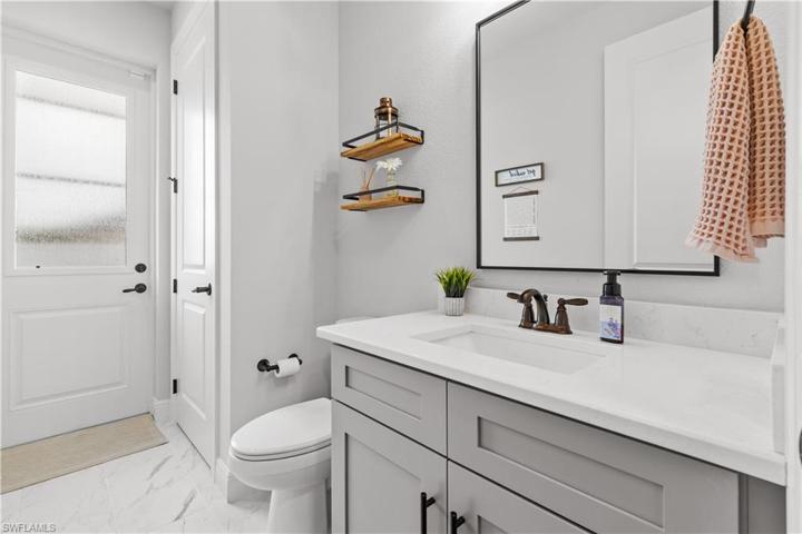 1/2 bath off kitchen with access to lanai.