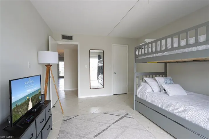 Bedroom featuring light tile floors