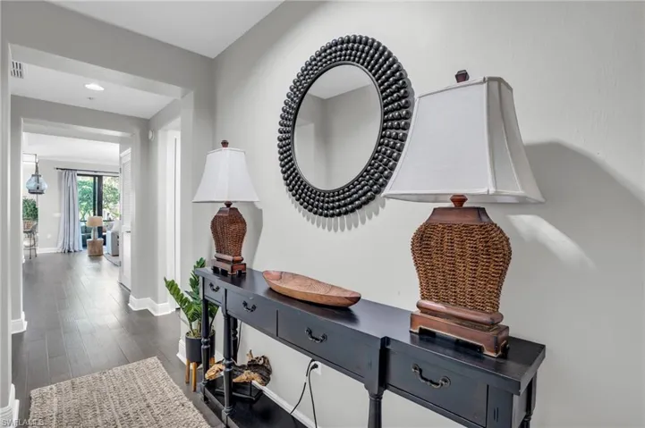Corridor featuring dark wood finished floors and baseboards
