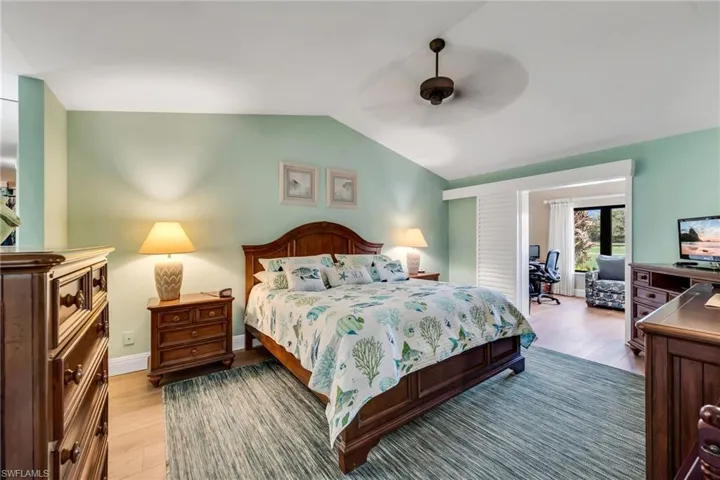 Bedroom featuring a desk, wood finished floors, and ceiling fan