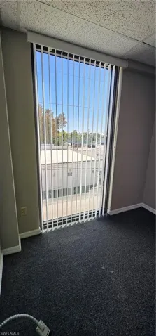 Detailed view of carpet floors and a drop ceiling