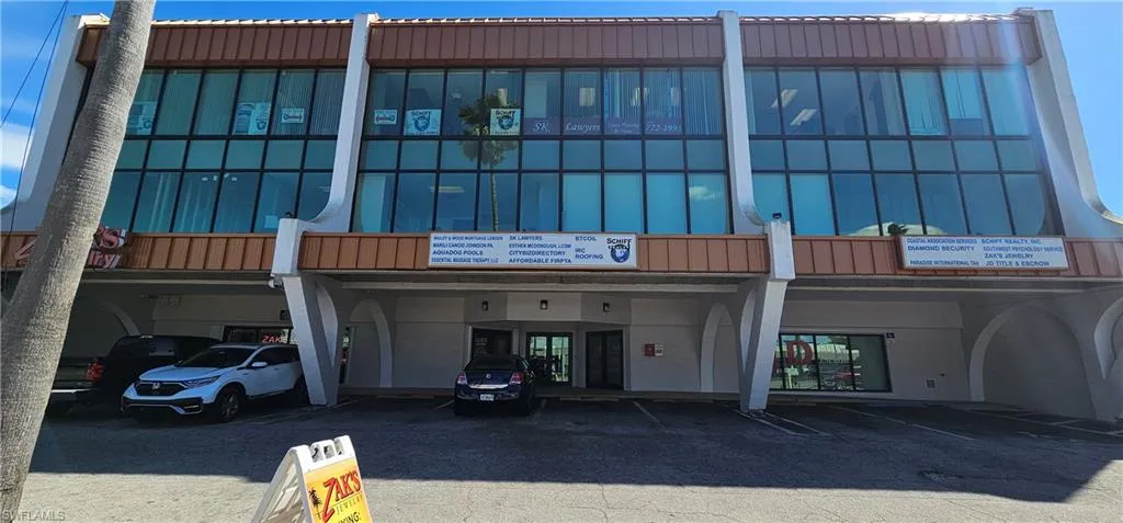 View of building exterior featuring covered parking