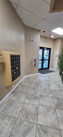 View of community with a drop ceiling, mail area, and french doors