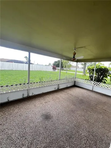 View of patio featuring ceiling fan and a sunroom