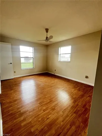Spare room with light wood finished floors and ceiling fan