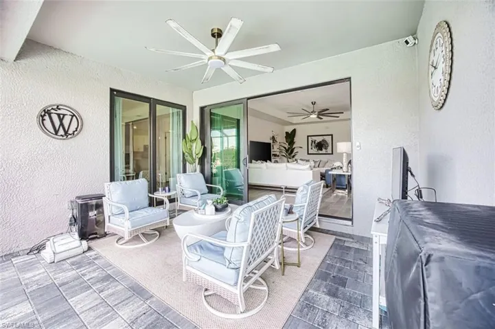View of patio with an outdoor hangout area and a ceiling fan