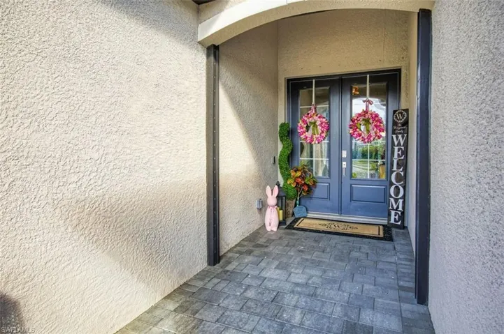 Doorway to property with french doors and stucco siding
