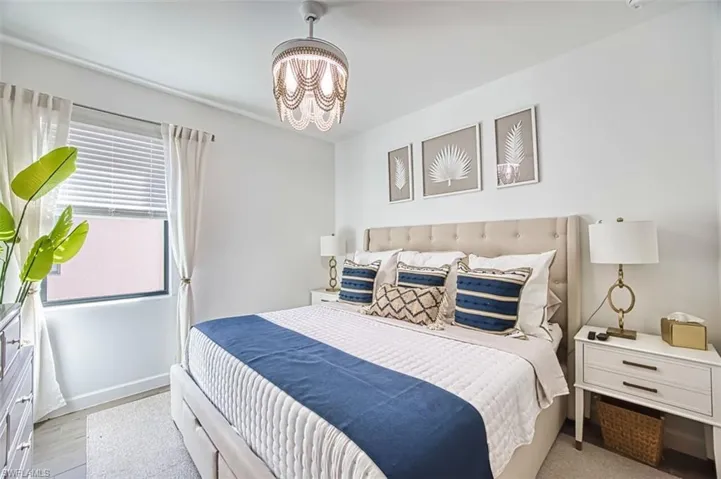 Bedroom with suspended lighting and baseboards