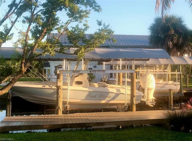 Composite boat dock with electric, 10,000 lb lift with cover.  Boat shown in photo is 24' in length