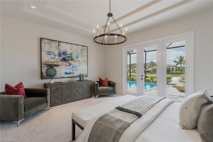 Primary suite with access to pool/spa and fire pit. Images of a previous model. This home may not include all features shown.