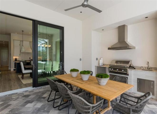 Spacious outdoor living with outdoor kitchen for entertaining. Images of a previous model. This home may not include all features shown.