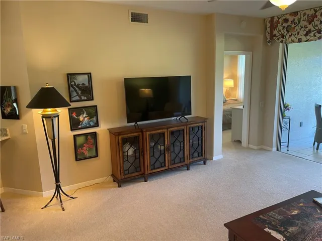 Living room featuring light carpet, visible vents, and baseboards
