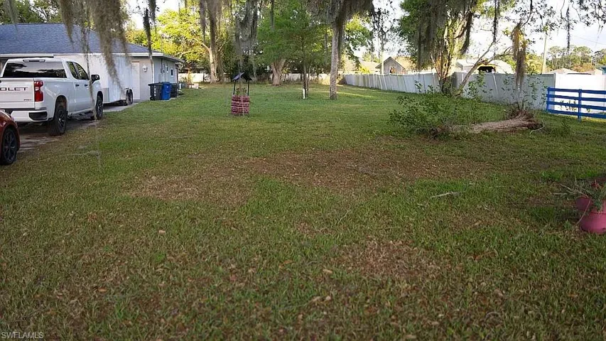 View of yard featuring fence