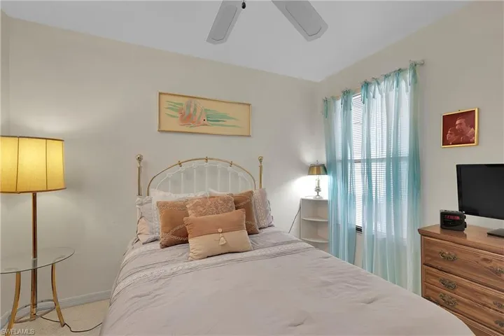Bedroom featuring a ceiling fan and baseboards