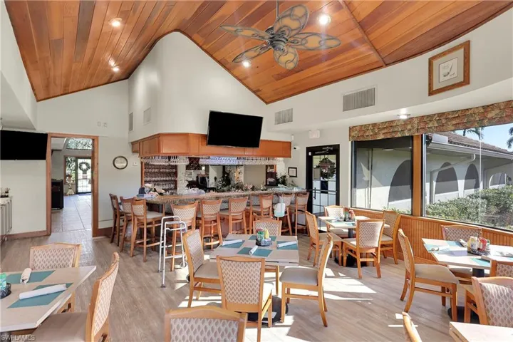 Dining area featuring wooden ceiling, light wood-type flooring, high vaulted ceiling, a ceiling fan, and recessed lighting