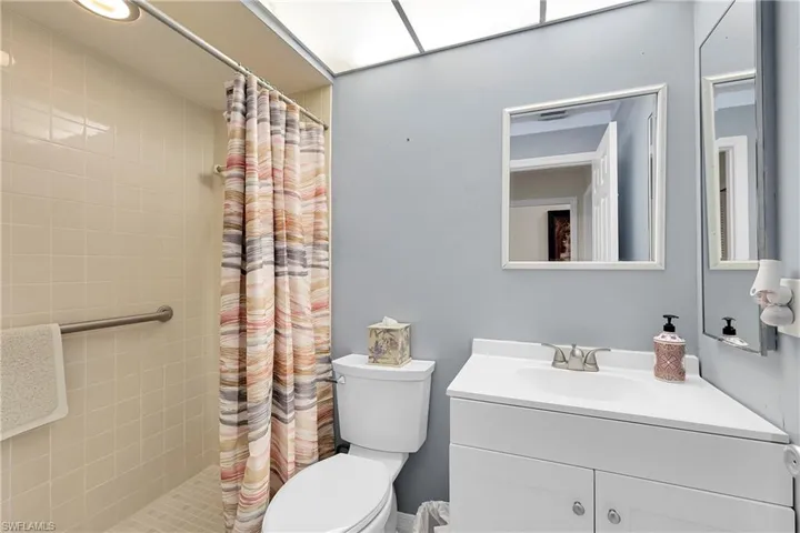 Full bathroom with vanity and a shower stall