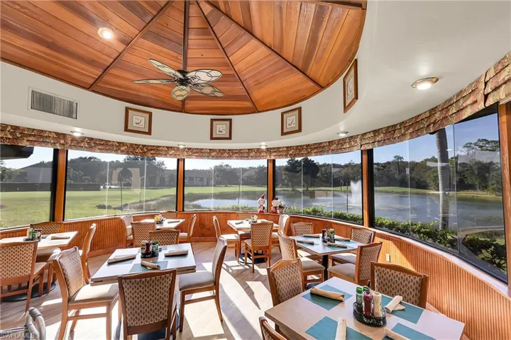 Sunroom featuring wooden ceiling, a water view, plenty of natural light, wood finished floors, and wood walls
