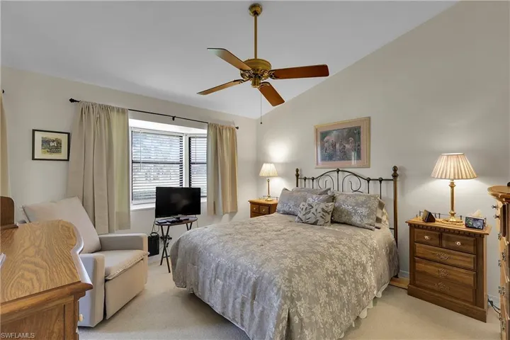 Master Bedroom with lofted ceiling, light colored carpet, and ceiling fan