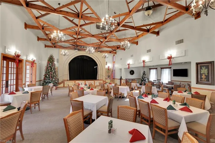 Dining space featuring a towering ceiling and carpet