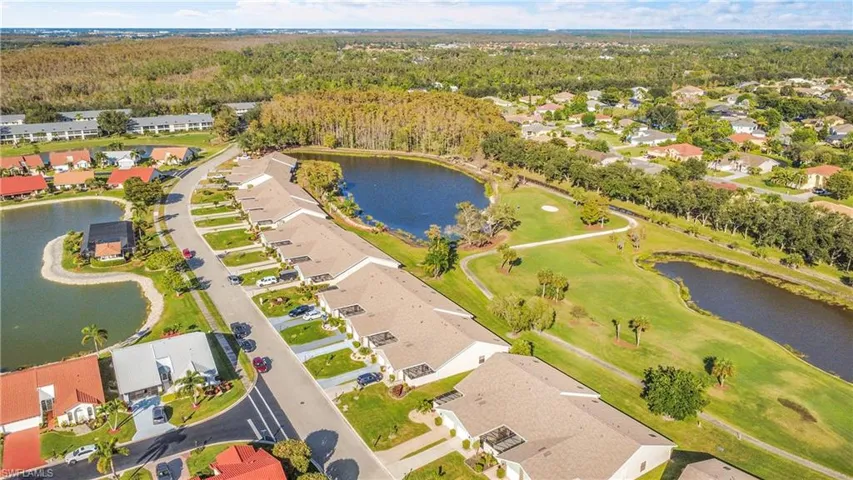 View of property location featuring a nearby body of water and nearby suburban area