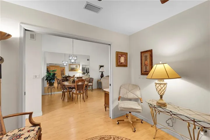 Sitting room with light wood-style flooring and a chandelier
