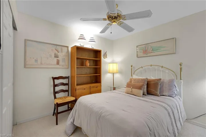 2nd Bedroom with light carpet and a ceiling fan
