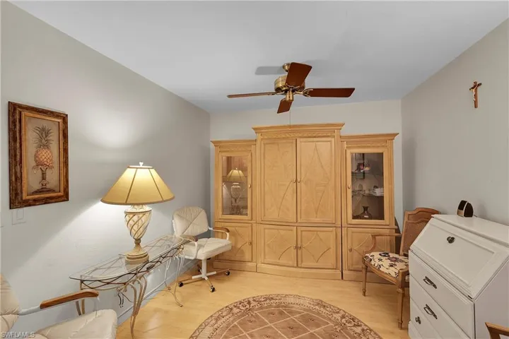 Living area featuring light wood-style floors and ceiling fan