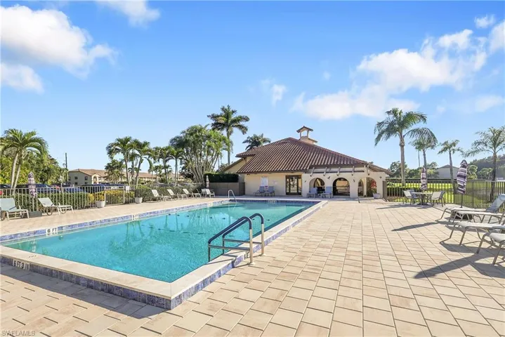 Community pool with a patio