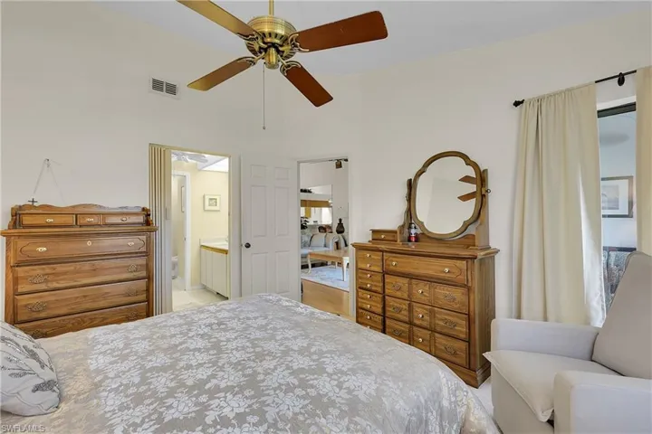 Bedroom featuring ceiling fan and ensuite bathroom