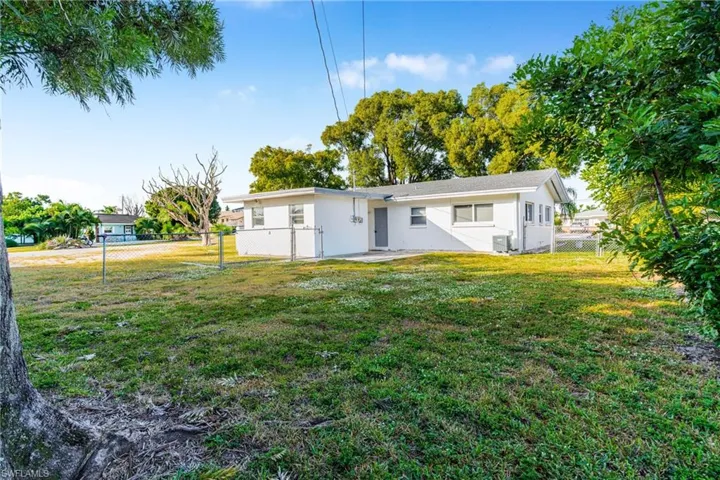 Back of property with a patio area and a fenced backyard