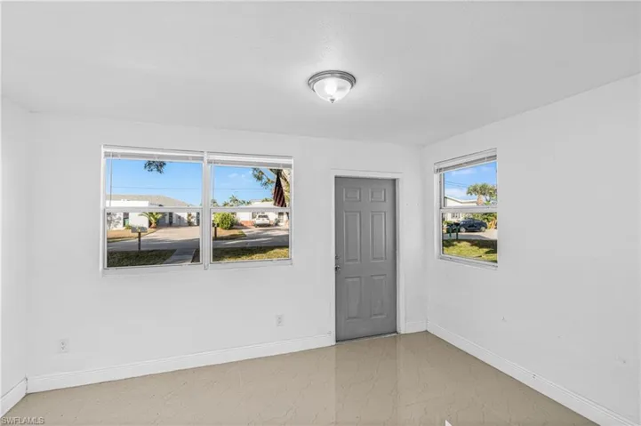 Empty room featuring baseboards and light marble finish floors