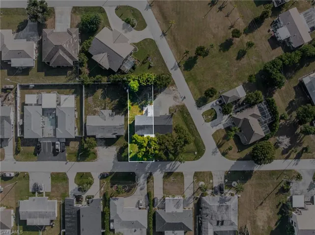 Aerial view of property's location featuring nearby suburban area