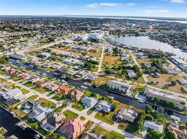 Aerial overview of property's location with a large body of water and nearby suburban area