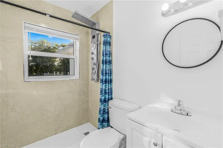 Full bath featuring a shower stall and vanity