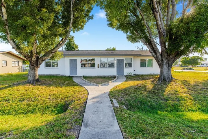 Single story home featuring a front lawn and stucco siding