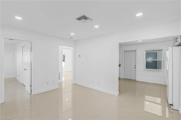 Unfurnished room with recessed lighting and light marble finish flooring