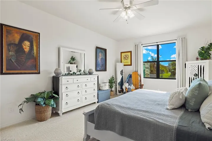 Kitchen featuring ceiling fan, hanging light fixtures, dishwasher, sink, and light tile patterned flooring