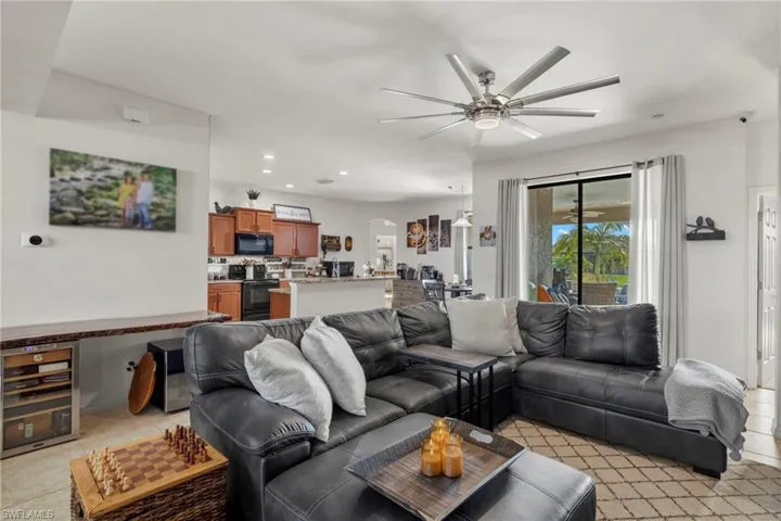 Living room featuring ceiling fan and light tile patterned floors