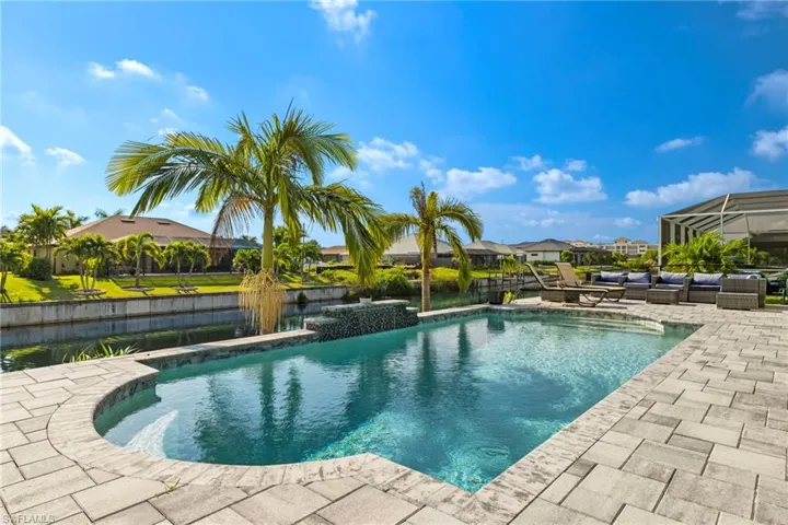View of pool featuring a lanai, outdoor lounge area, and a patio