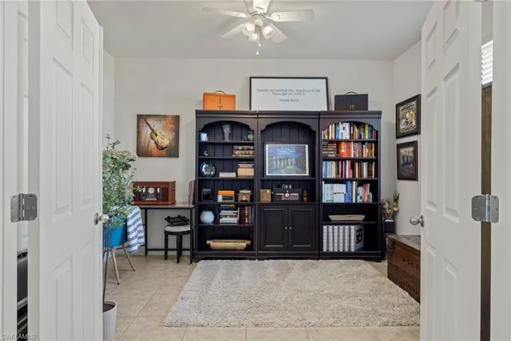 Tiled office space featuring ceiling fan