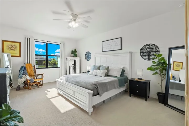 Carpeted bedroom with ceiling fan