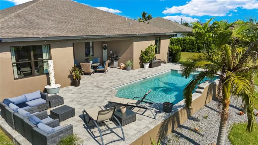 View of swimming pool with a grill, a patio area, and an outdoor hangout area