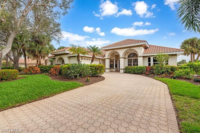 Front exposure with pavered driveway.