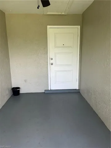 Doorway to property with stucco siding