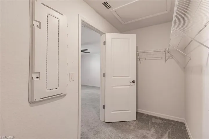 Walk in closet featuring carpet flooring and ceiling fan